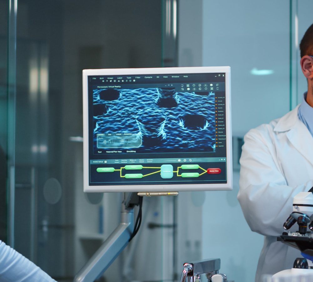 Group of researchers checking virus evolution conducting vaccine development with help of high tech, analysing results and planning next steps working late at night in modern equipped laboratory